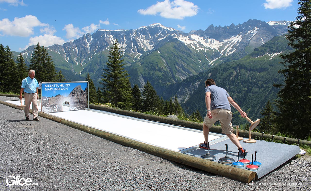 Eisstock on Glice synthetic ice with Swiss Alps panorama