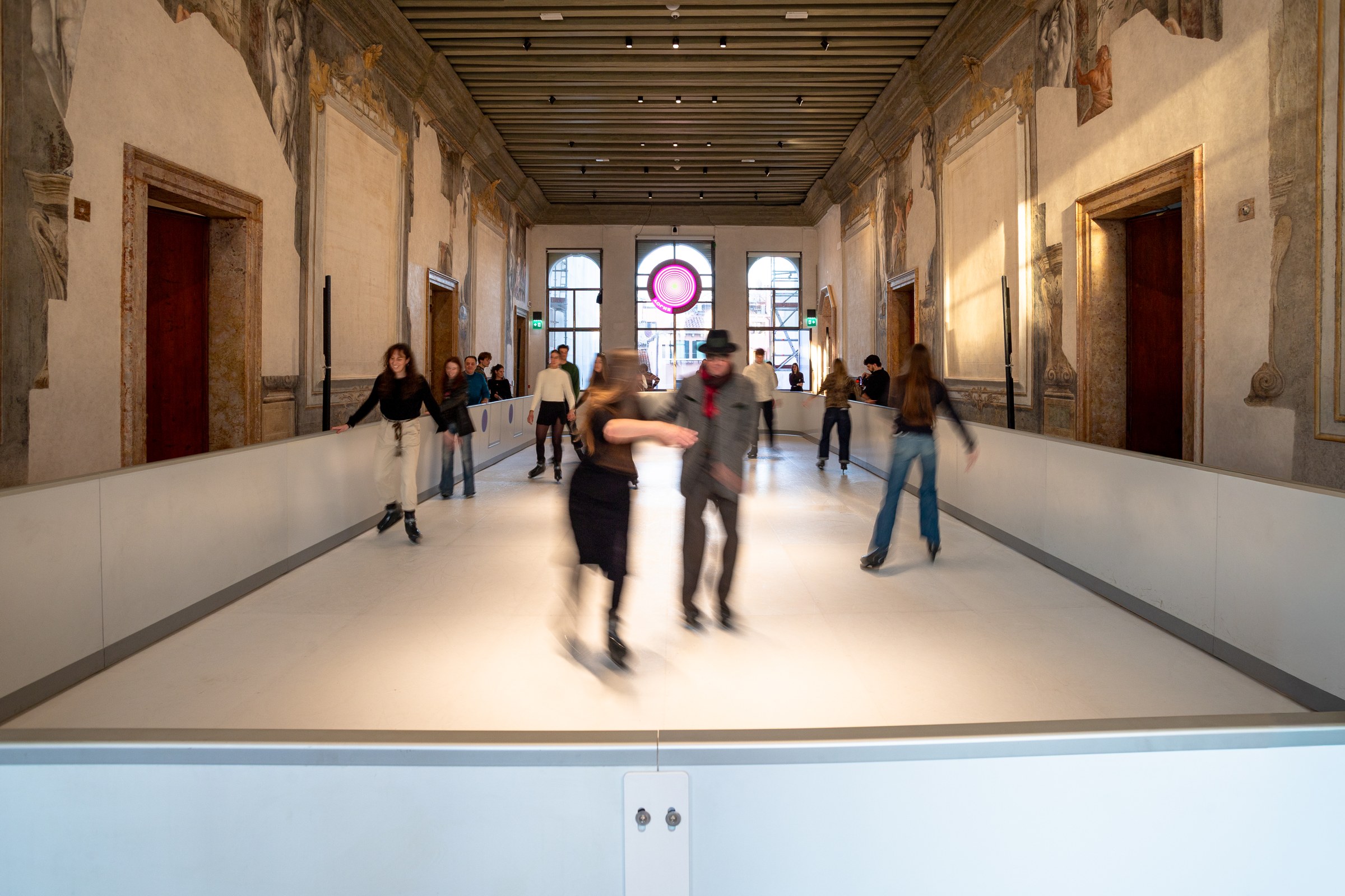 Visitors skating inside the decorated halls of Palazzo Diedo in Venice