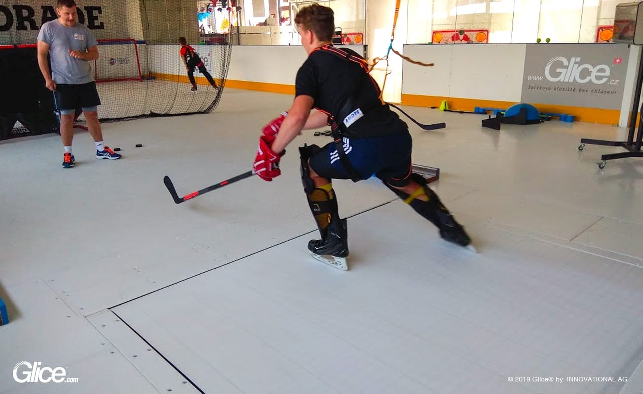 Hockey player skating on Glice synthetic ice during training session