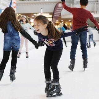 Children Having Fun On Synthetic Ice Rink At Swiss Mall