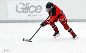 Ice hockey player on a Glice rink