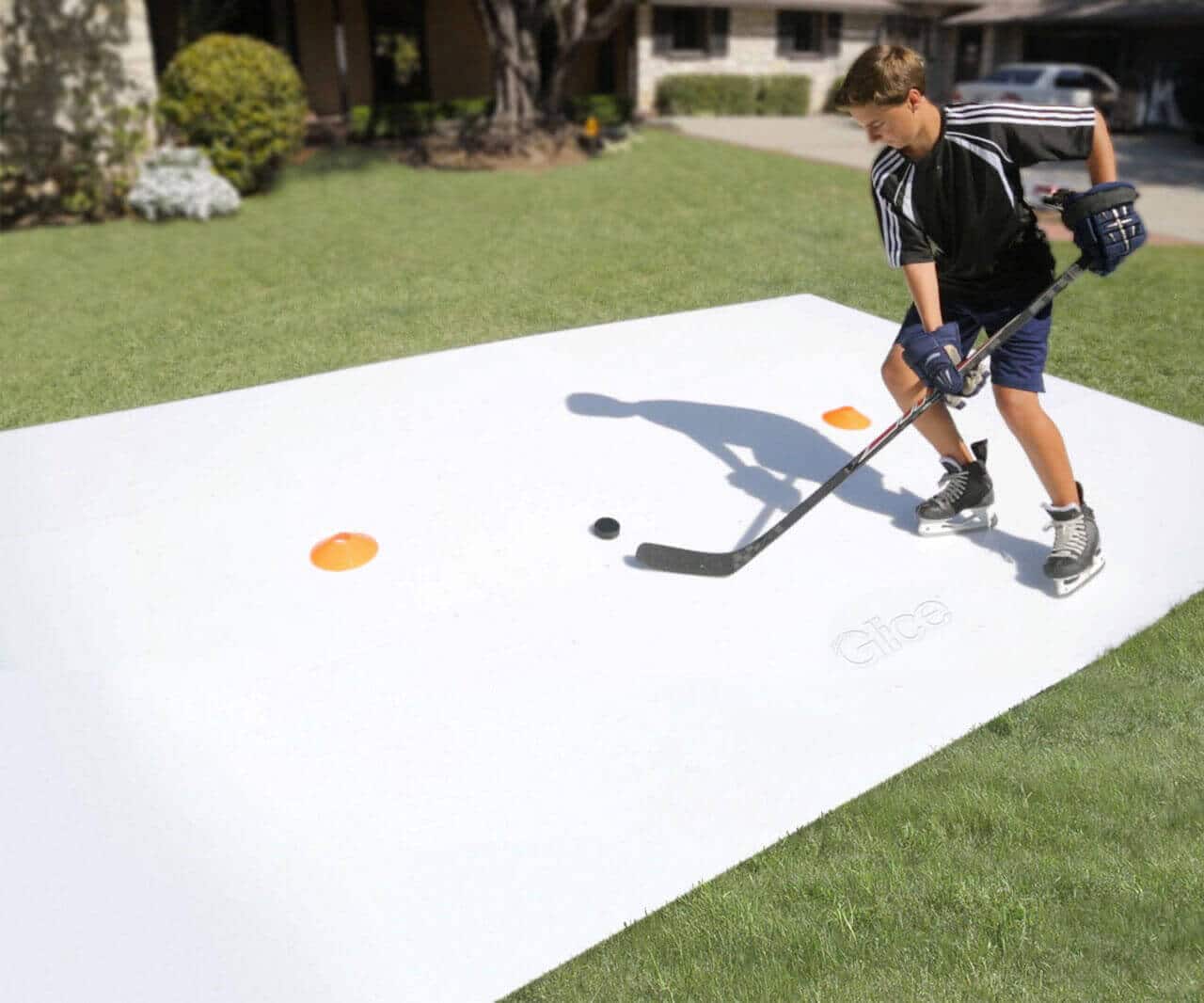 Boy training stick handling on synthetic ice sheet 1