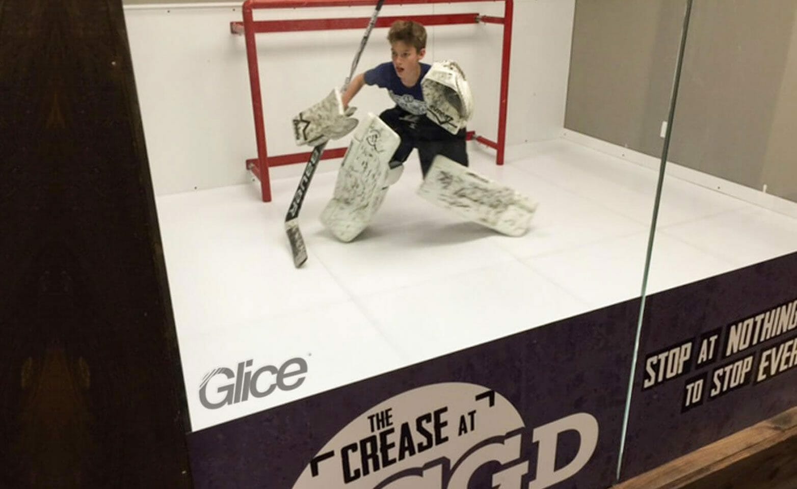 Child as a hockey goalie on artificial ice pad
