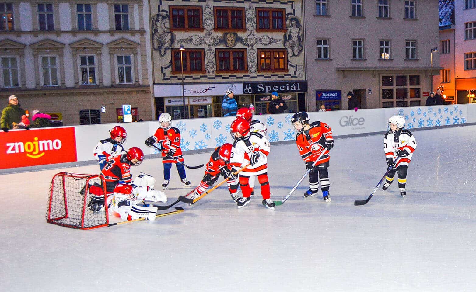 Children hockey match in city center on synthetic ice rink
