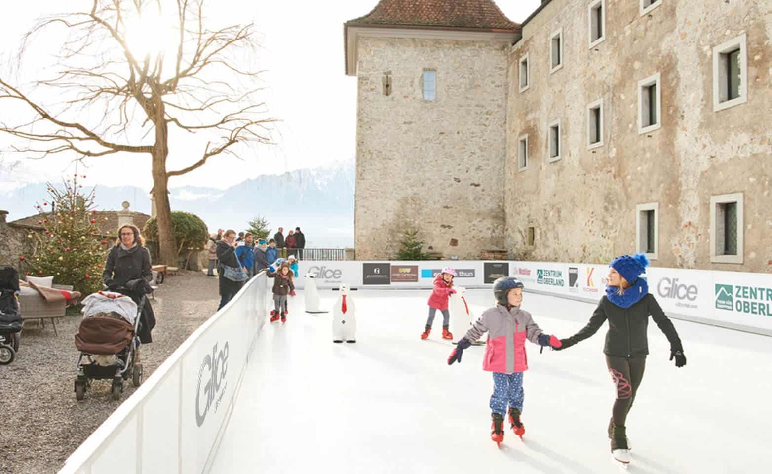 Christmas skating on synthetic ice rink in front of castle