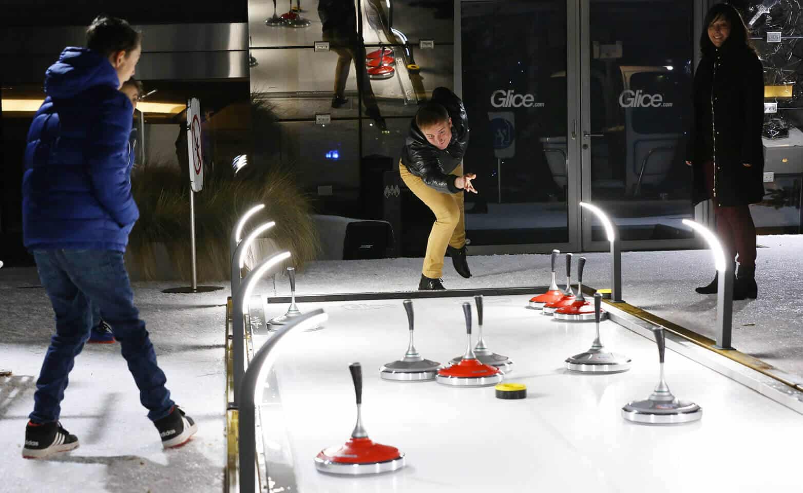 Eisstock curling game on synthetic curling lane