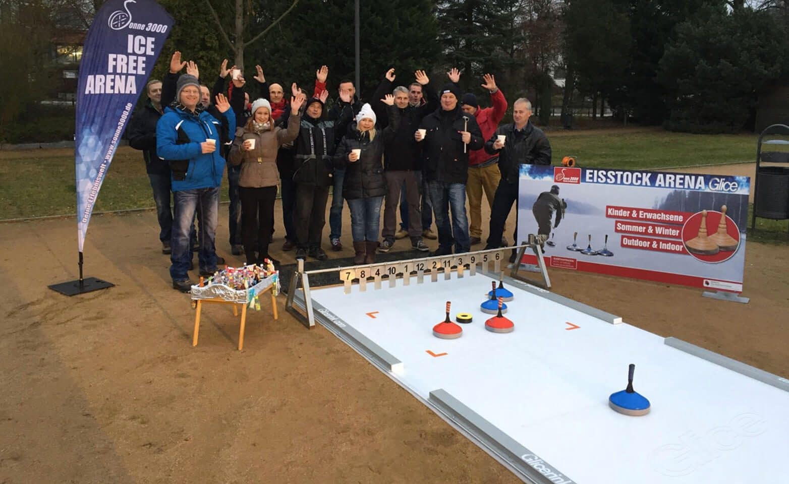 Employees enjoying Eisstock game on synthetic track at company event