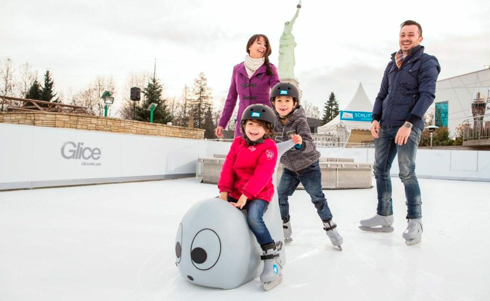 Family skating fun on synthetic ice rink at Austrian amusement park