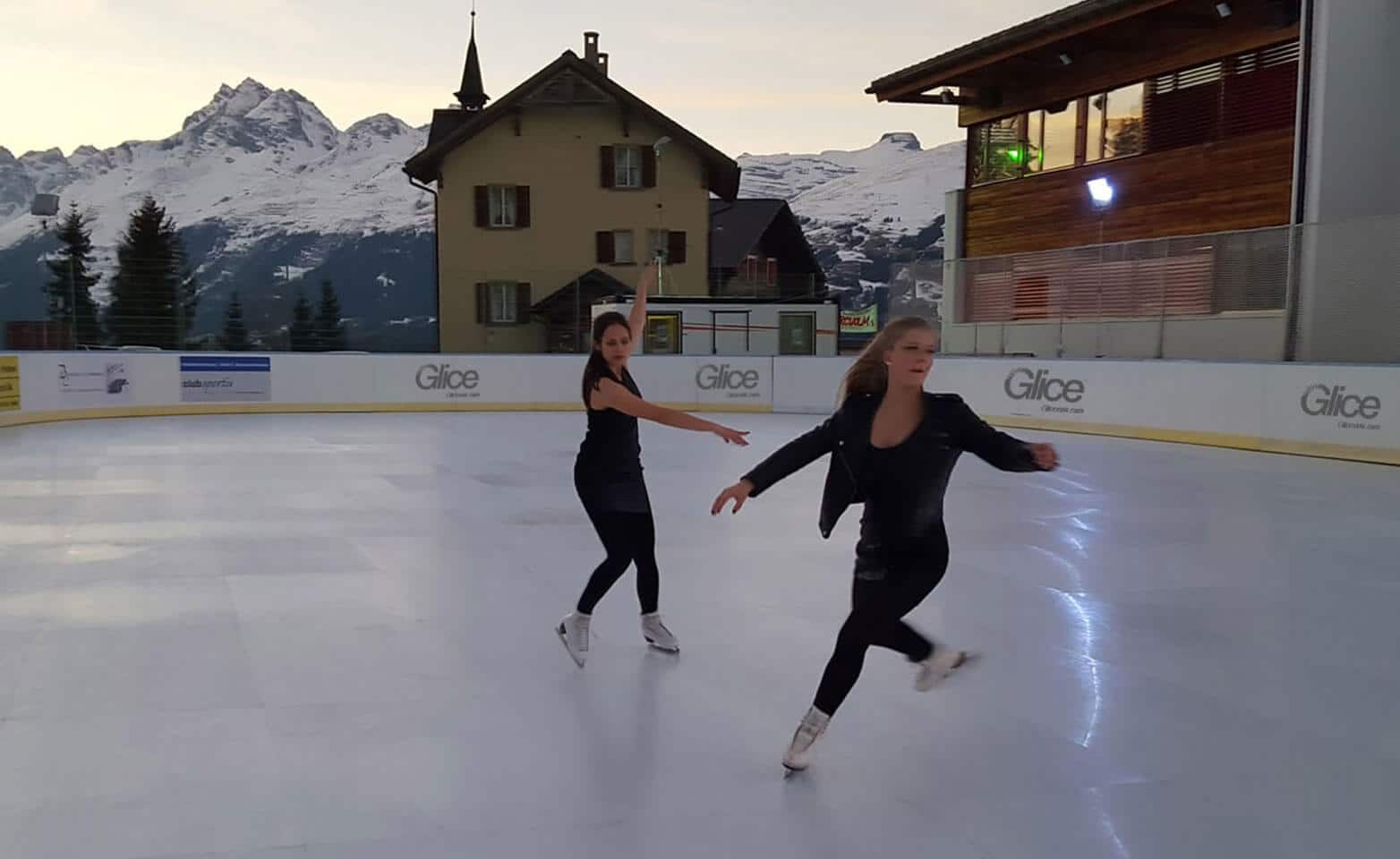 Figure skaters on artificial ice rink at famous Swiss ski resort