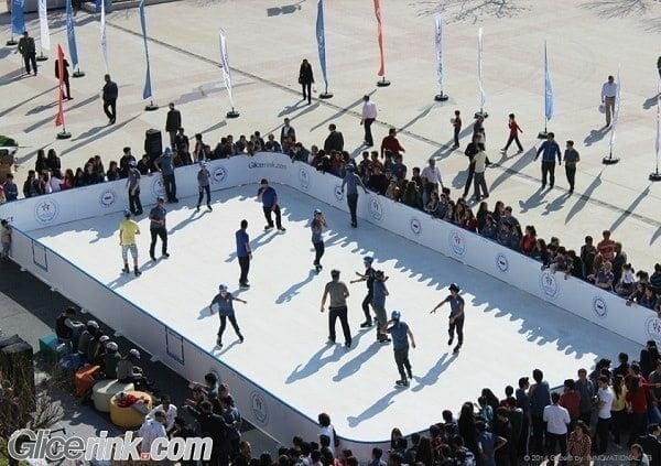 People skating on an outdoor synthetic ice rink in Dubai - synthetic ice vs. real ice