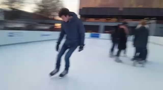 Young guy gliding on synthetic ice rink in Zurich