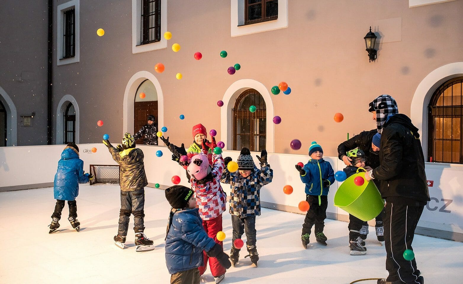 Kids having fun on plastic ice rink during Christmas season