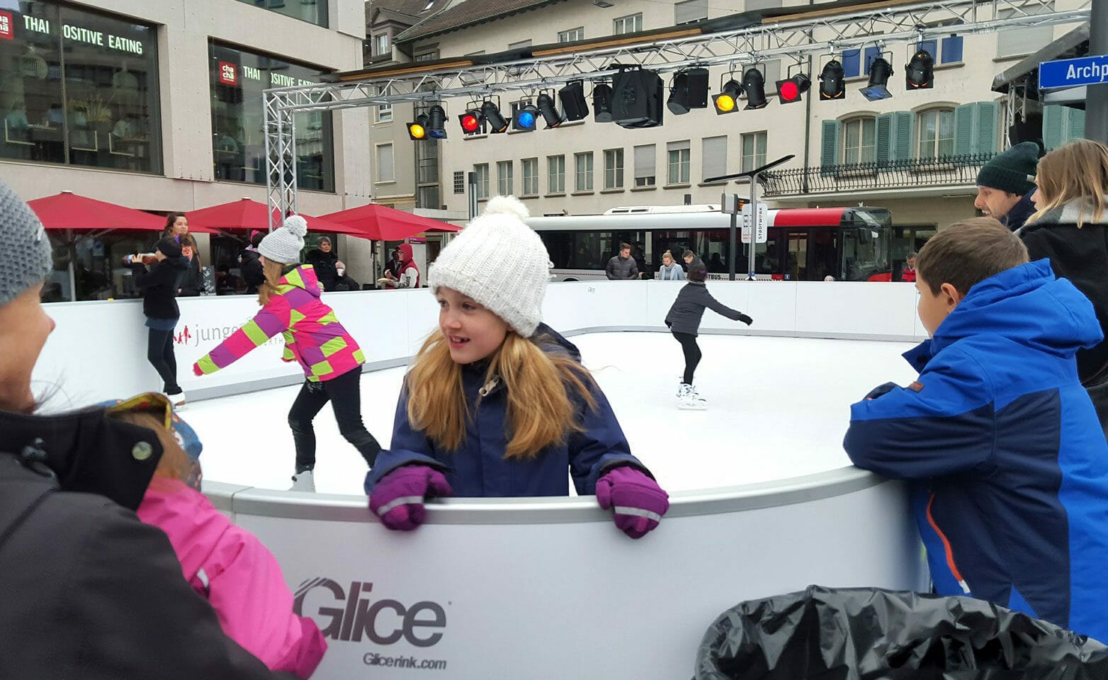 Kids on a Christmas synthetic ice rink in Swiss town center