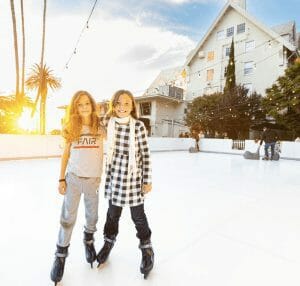 Two girls smiling on ice skating rink