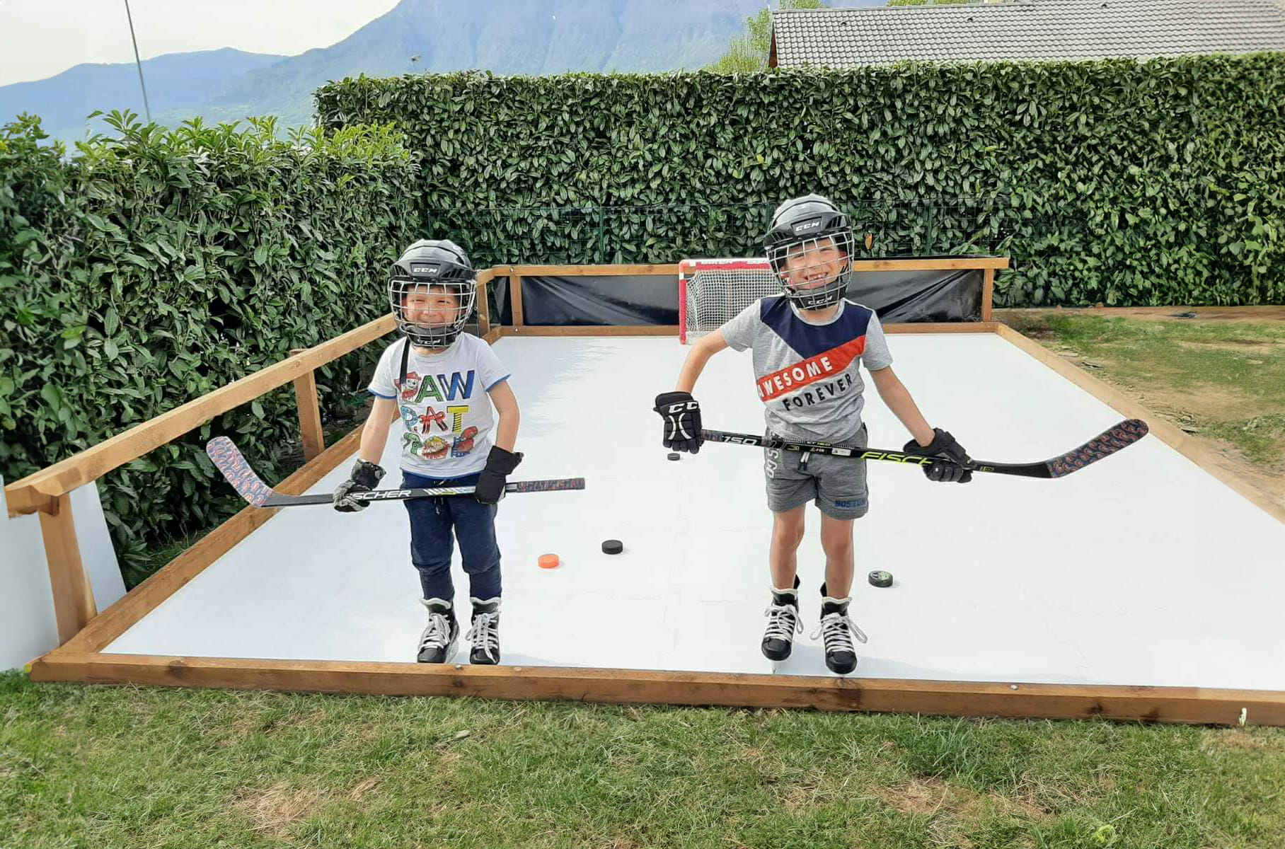 Two boys happy on their synthetic ice rink