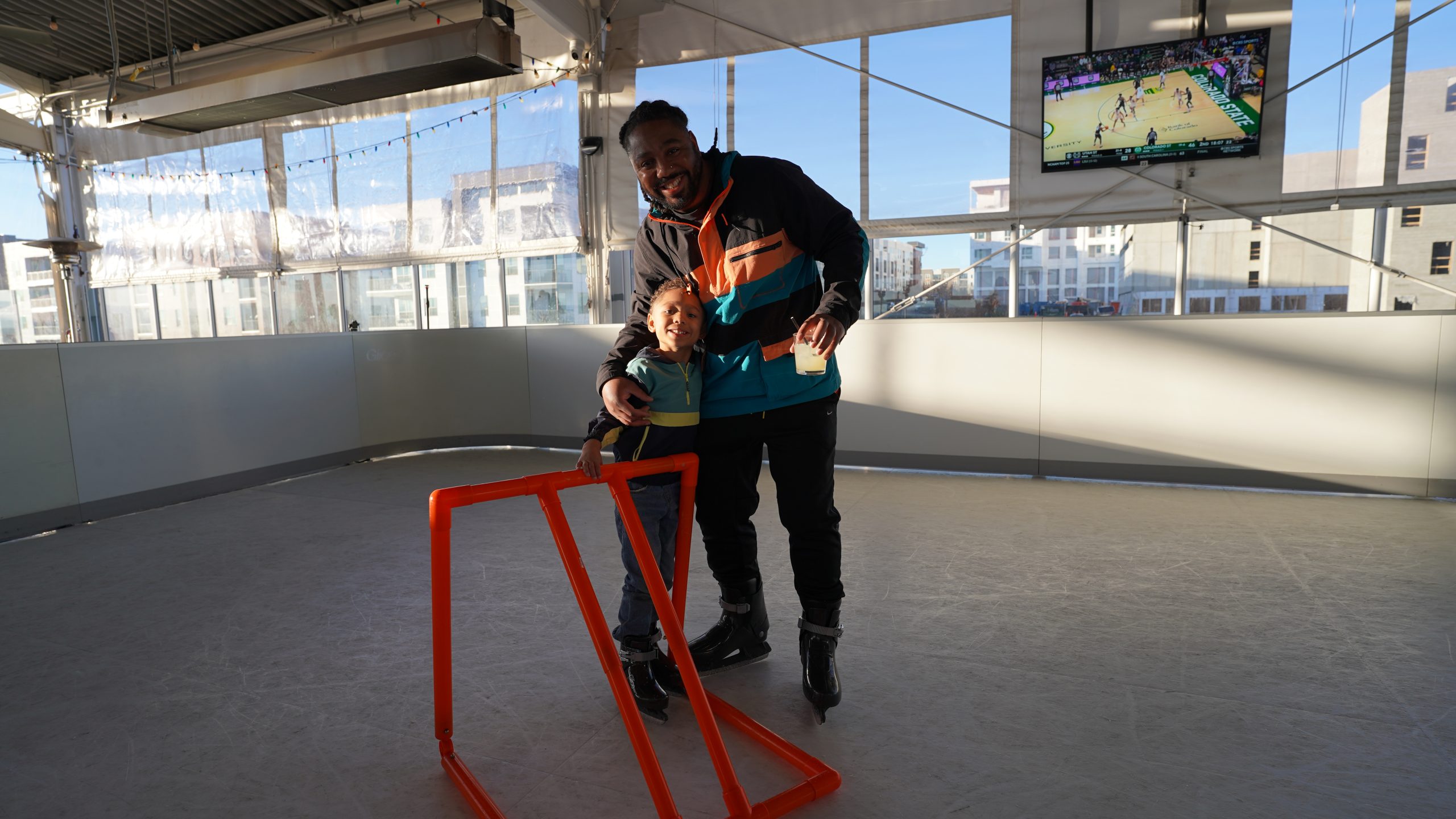 Father and son posing on ice surface