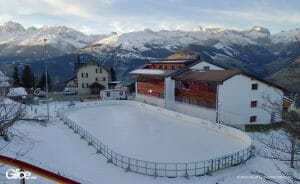 Synthetic ice rink in winterly setting