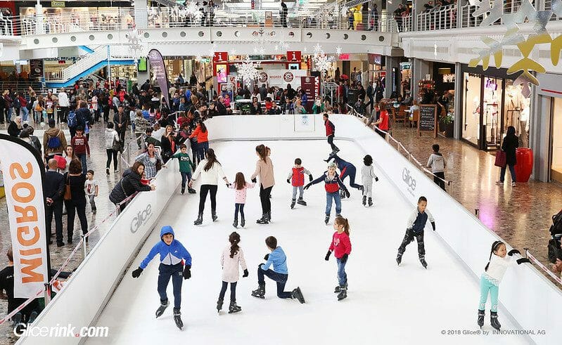 Crowded synthetic ice rink at mall