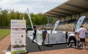 Glice personnel setting up Glice rink in a stadium to promote their tree planting initiative