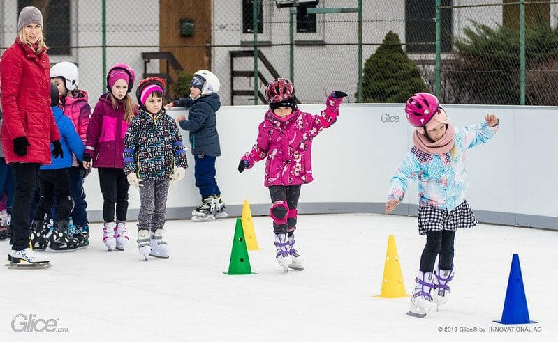 Kids learning how to ice skate on synthetic ice